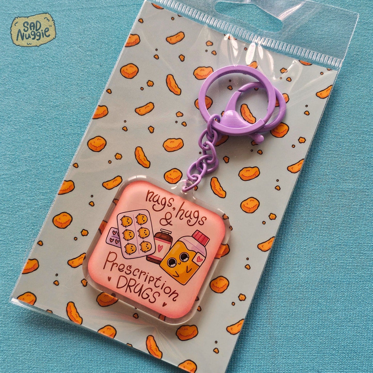 Sad Nuggie Nugs, Hugs, & Prescription Drugs Epoxy Keychain